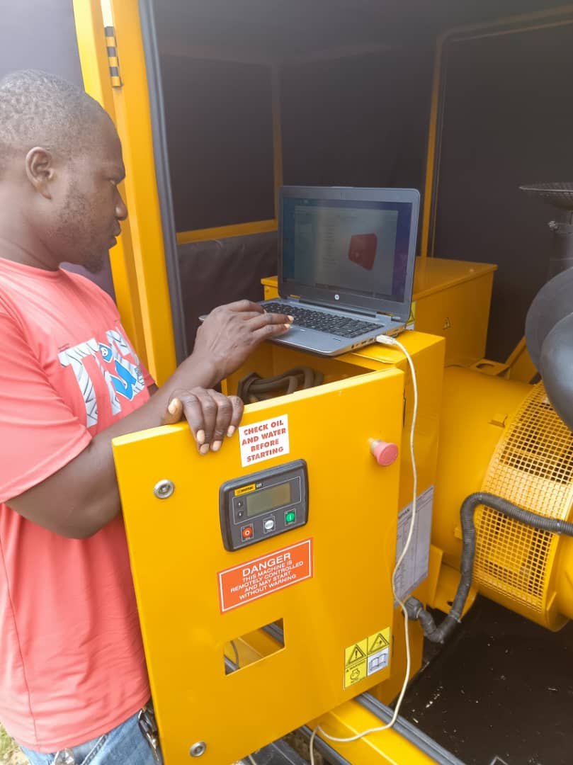 Diamond Power technician programming a generator control panel